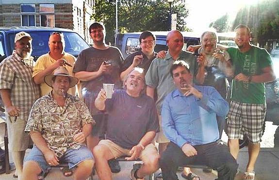 Marvin Mirick with a group of men smoking cigars outdoors